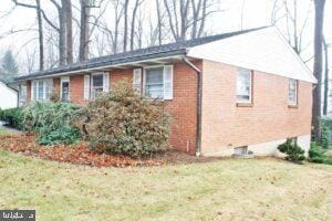 view of side of home featuring a yard