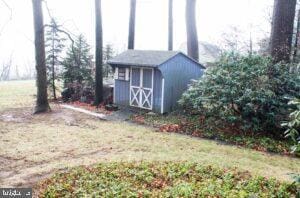 view of outbuilding with a yard