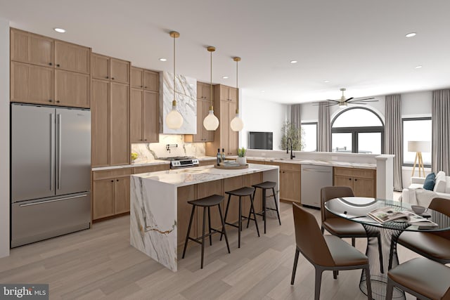 kitchen with dishwasher, a kitchen island, a kitchen breakfast bar, hanging light fixtures, and stainless steel fridge