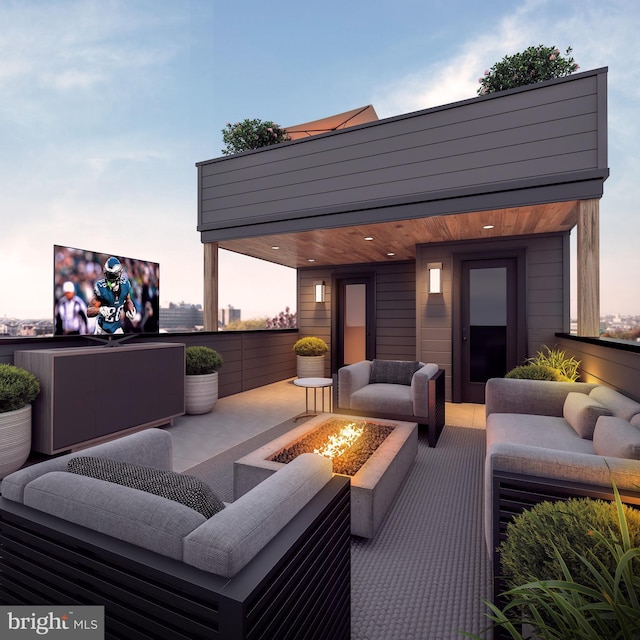 patio terrace at dusk featuring an outdoor living space with a fire pit