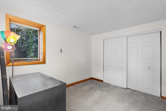 unfurnished office featuring carpet and a textured ceiling