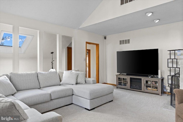 carpeted living room with vaulted ceiling