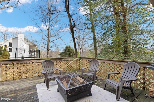 wooden terrace featuring an outdoor fire pit