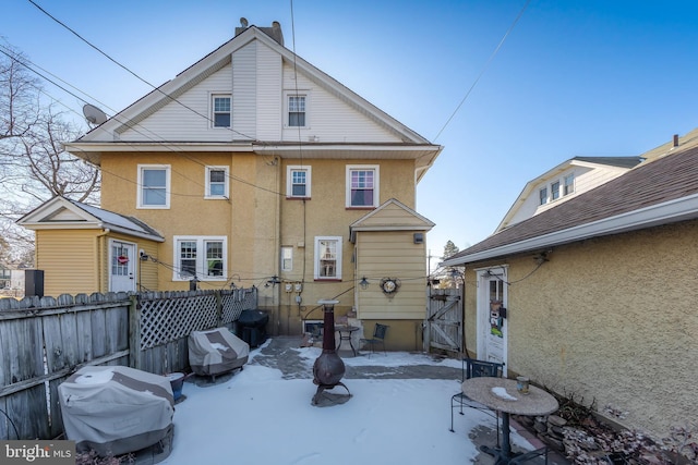 view of snow covered rear of property