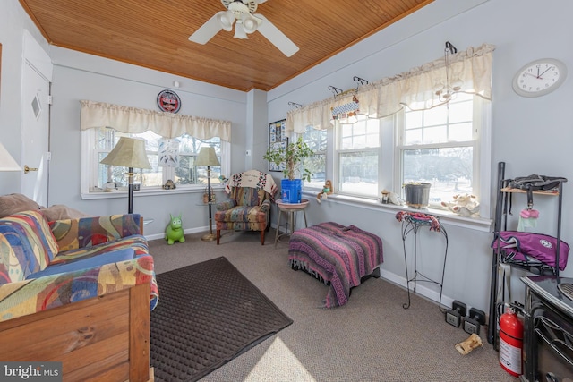 interior space with carpet floors, wooden ceiling, and ceiling fan