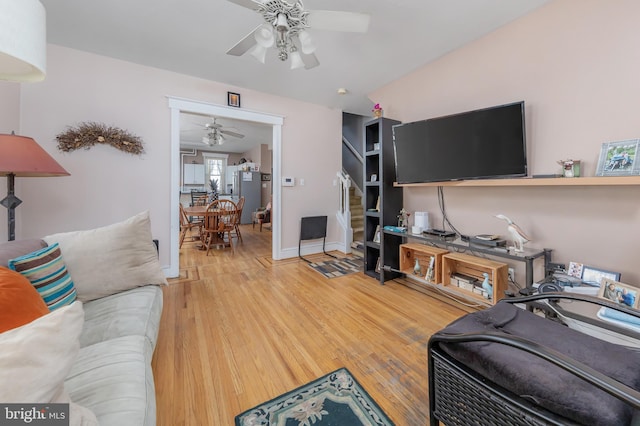 living room featuring hardwood / wood-style flooring and ceiling fan