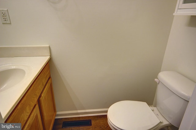 bathroom featuring hardwood / wood-style flooring, vanity, and toilet