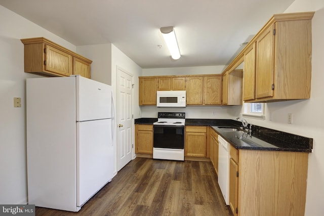 kitchen featuring white appliances, dark wood-type flooring, and sink