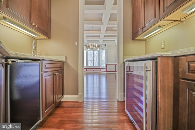 kitchen with baseboards, coffered ceiling, wine cooler, dark wood-type flooring, and beam ceiling