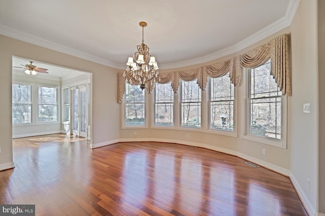 unfurnished dining area featuring ornamental molding, visible vents, baseboards, and wood finished floors