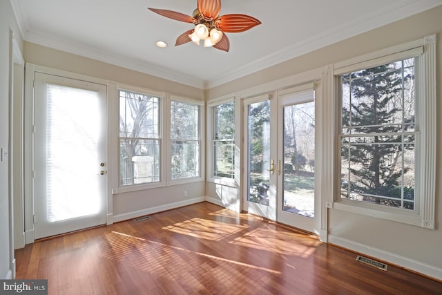 unfurnished sunroom with a ceiling fan and visible vents