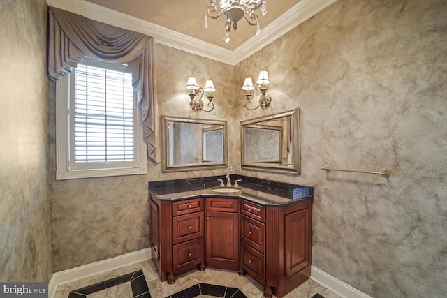 bathroom featuring baseboards, ornamental molding, a chandelier, and vanity