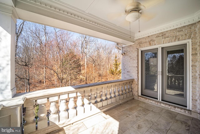 exterior space with ceiling fan and a balcony