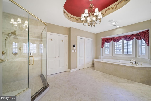 full bath with a raised ceiling, an inviting chandelier, a garden tub, a shower stall, and a closet