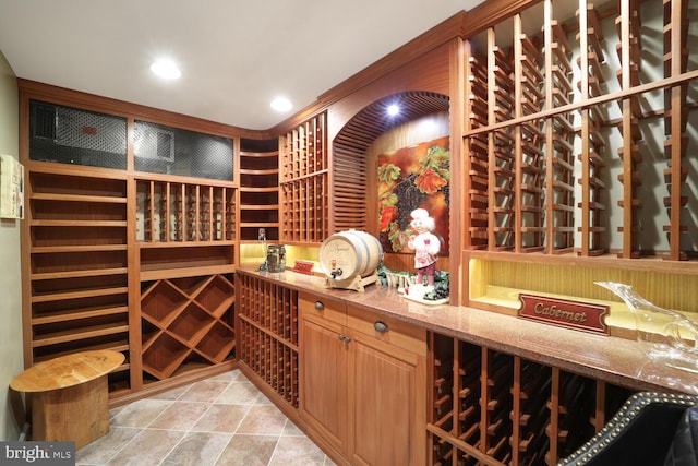 wine area featuring light tile patterned floors and recessed lighting