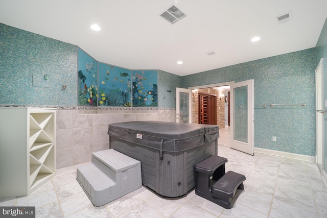 view of patio / terrace with an indoor hot tub and visible vents