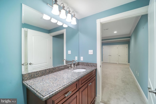 bathroom featuring ornamental molding, visible vents, vanity, and baseboards