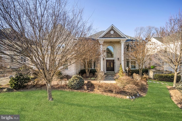 greek revival inspired property with a front lawn