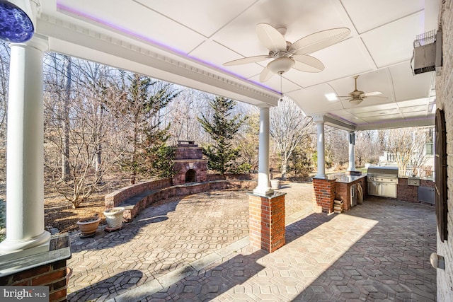 view of patio / terrace featuring area for grilling, exterior fireplace, and an outdoor kitchen