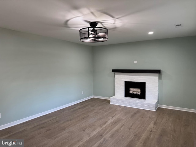 unfurnished living room with hardwood / wood-style flooring and a fireplace