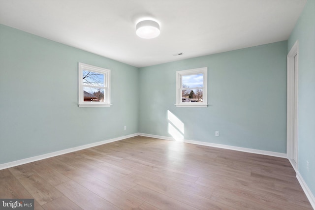 spare room featuring light hardwood / wood-style floors