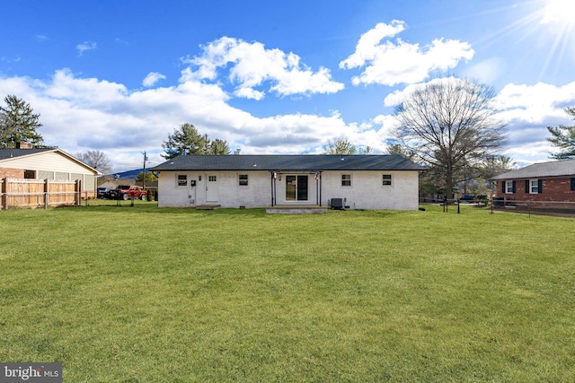 back of house featuring central AC and a lawn