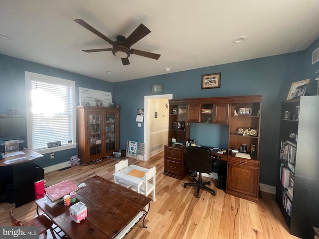 office space with ceiling fan and light hardwood / wood-style flooring