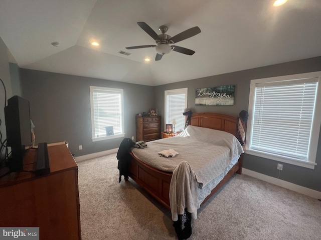 bedroom featuring light colored carpet, a raised ceiling, ceiling fan, and lofted ceiling