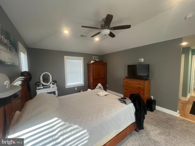 bedroom featuring ceiling fan, light carpet, and lofted ceiling