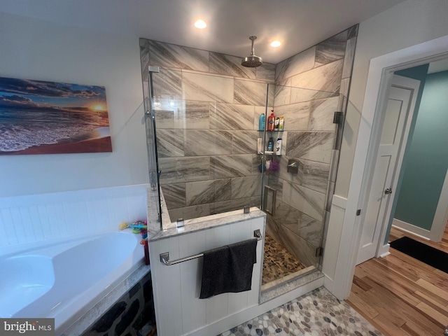 bathroom featuring separate shower and tub and hardwood / wood-style floors