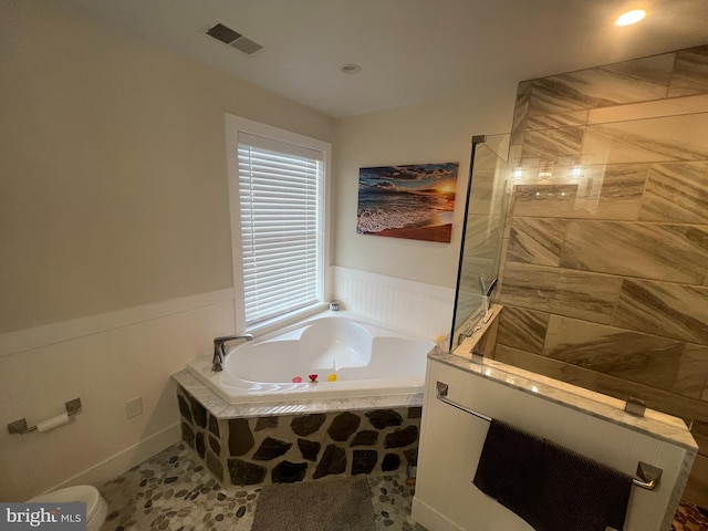 bathroom featuring tile patterned flooring and shower with separate bathtub