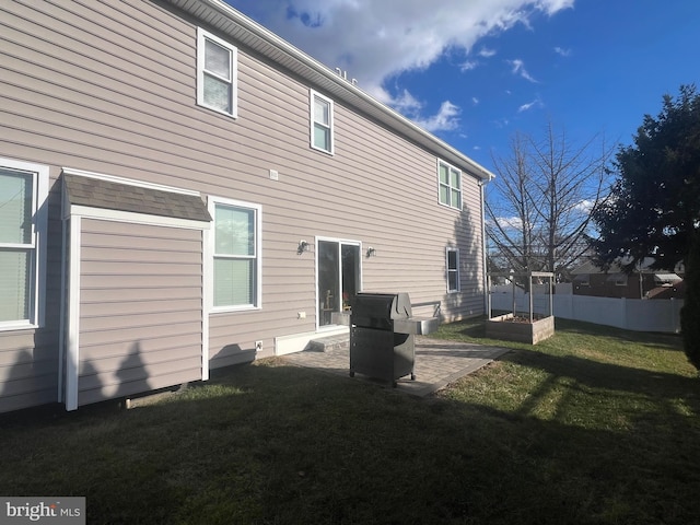 rear view of property with a lawn