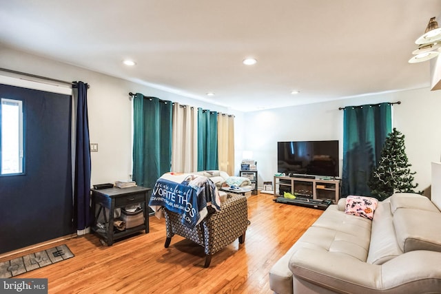 living room with light wood finished floors and recessed lighting