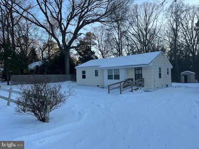 view of front of home with a shed