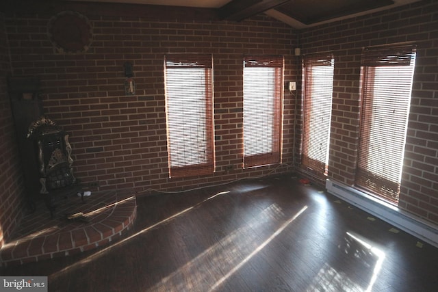 unfurnished room featuring vaulted ceiling with beams