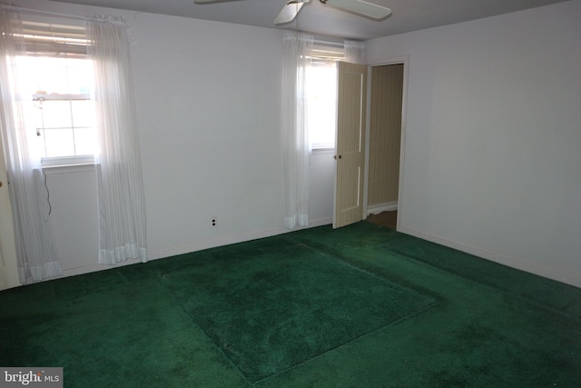 carpeted spare room with ceiling fan