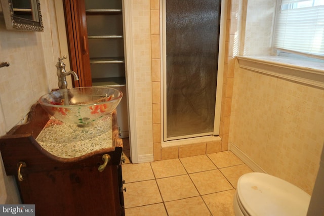 bathroom with tile patterned flooring, vanity, toilet, and an enclosed shower