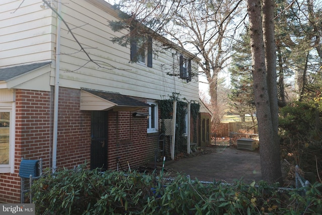 view of side of property with a patio area