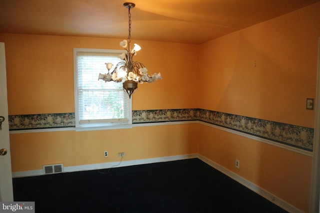 spare room with an inviting chandelier