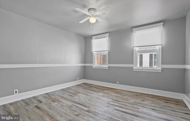 empty room with light hardwood / wood-style floors and ceiling fan