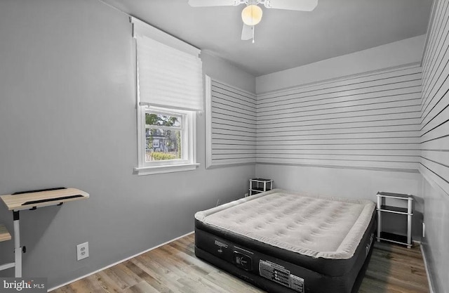 bedroom with ceiling fan and hardwood / wood-style flooring