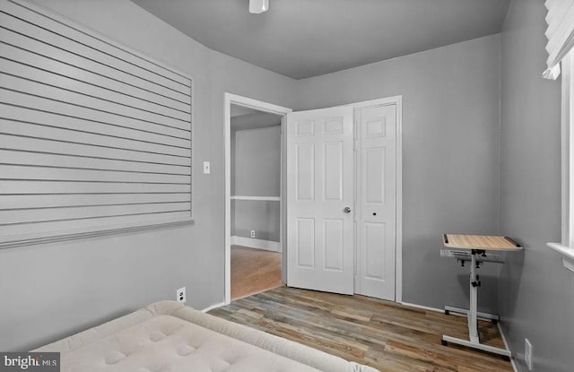 unfurnished bedroom with hardwood / wood-style floors and a closet