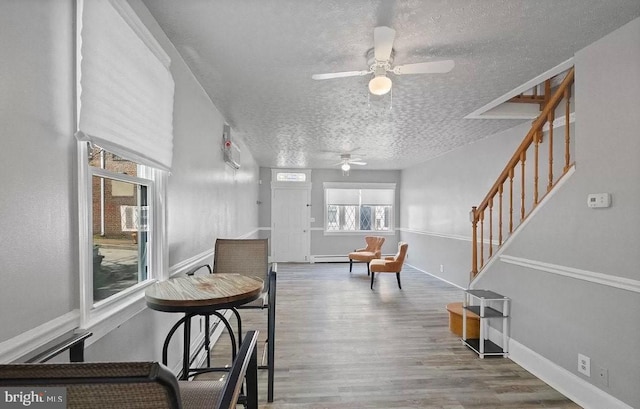 interior space featuring hardwood / wood-style flooring and a textured ceiling