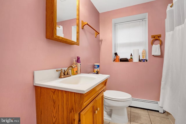 bathroom with tile patterned floors, toilet, vanity, and a baseboard heating unit