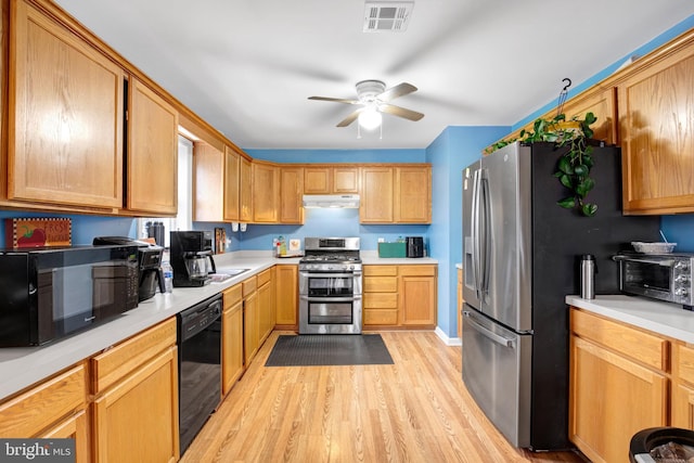 kitchen featuring black appliances, ceiling fan, and light hardwood / wood-style floors