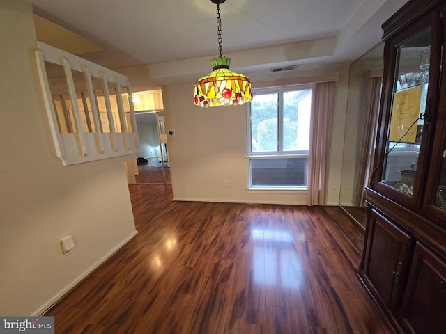 unfurnished dining area featuring dark wood-type flooring