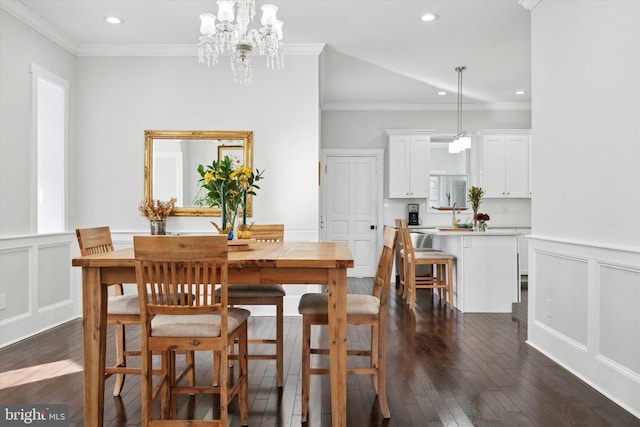 dining room with dark hardwood / wood-style flooring, a chandelier, and ornamental molding