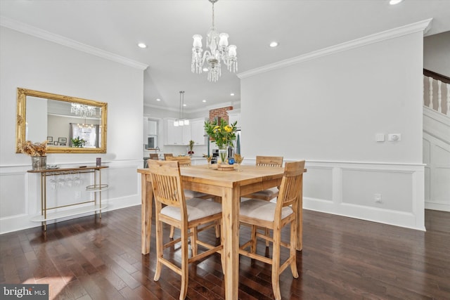 dining area with dark hardwood / wood-style floors, ornamental molding, and a chandelier