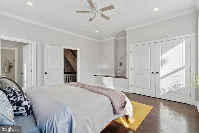 bedroom with dark hardwood / wood-style flooring, ceiling fan, and crown molding