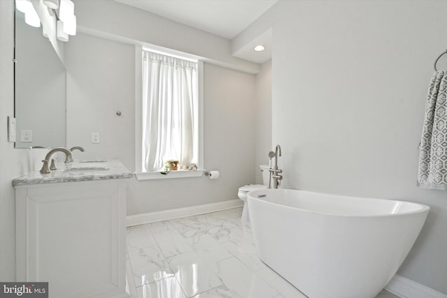 bathroom featuring vanity, toilet, and a bath